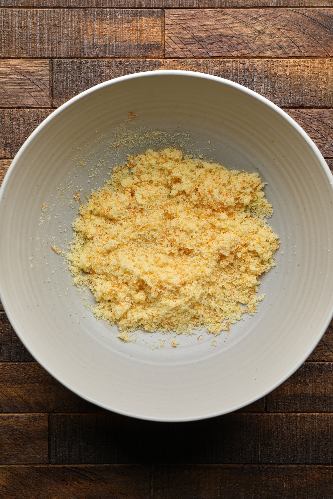 The orange zest and sugar mixed in a large bowl.