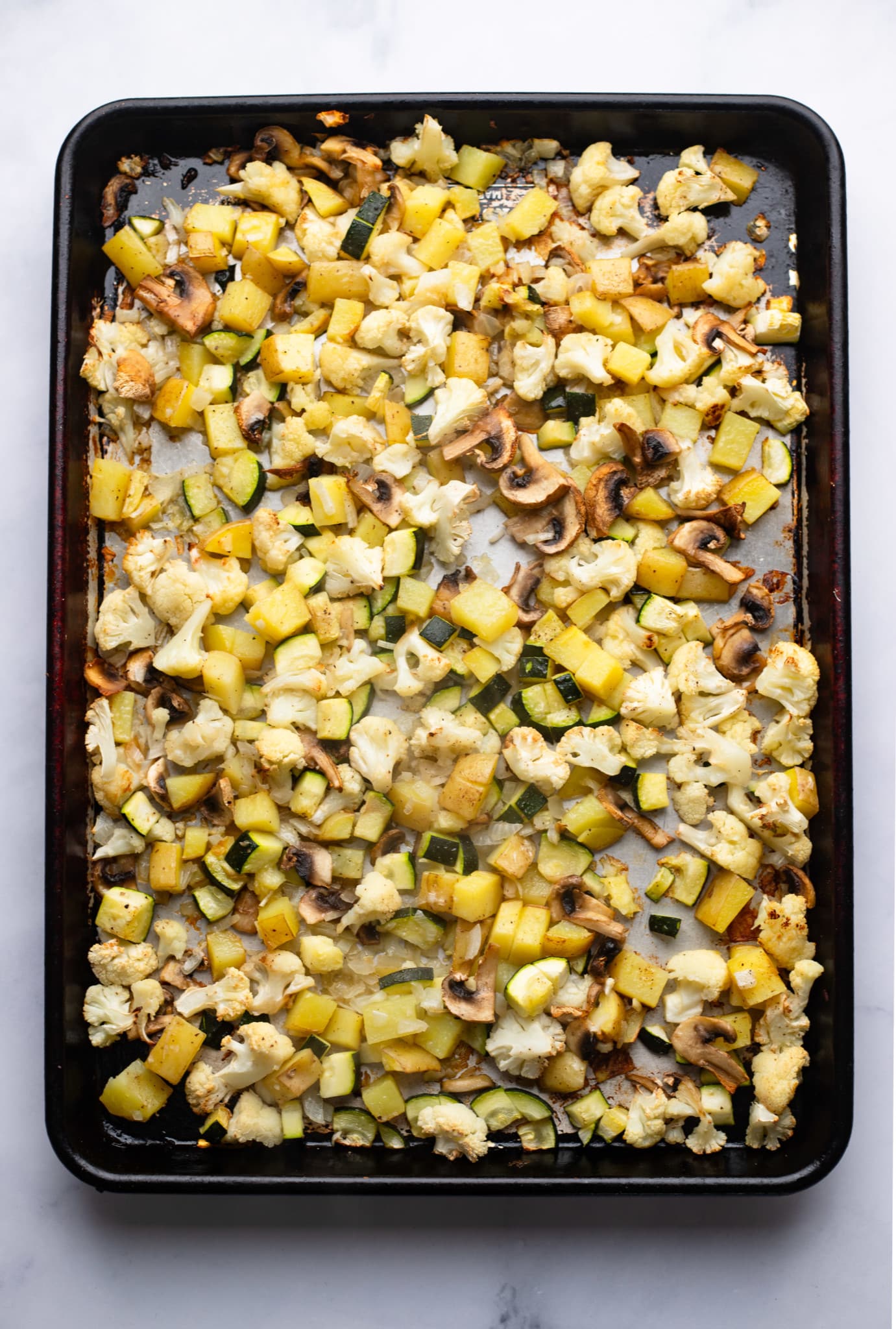 Roasted vegetables on a baking sheet.